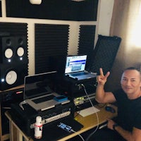 a man posing for a photo in a recording studio