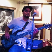 a man playing a bass in a bar